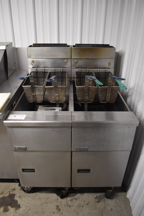 2012 Pitco Frialator SG14 Stainless Steel Commercial 2 Bay Natural Gas Powered Deep Fat Fryer w/ 4 Metal Fry Baskets on Commercial Casters. 110,000 BTU. 31.5x34x48