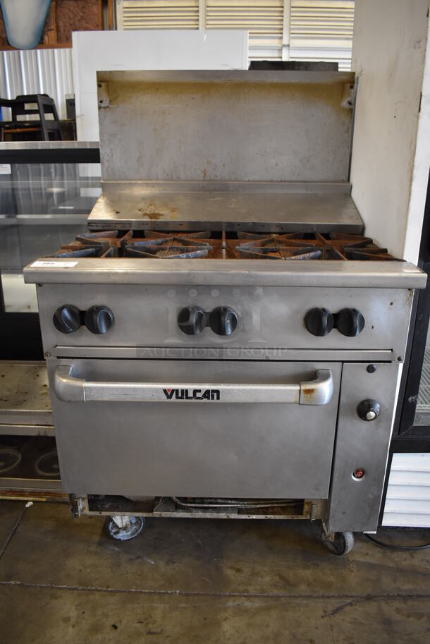 Vulcan Stainless Steel Commercial Natural Gas Powered 6 Burner Range w/ Oven, Back Splash and Over Shelf on Commercial Casters. 36x35x59