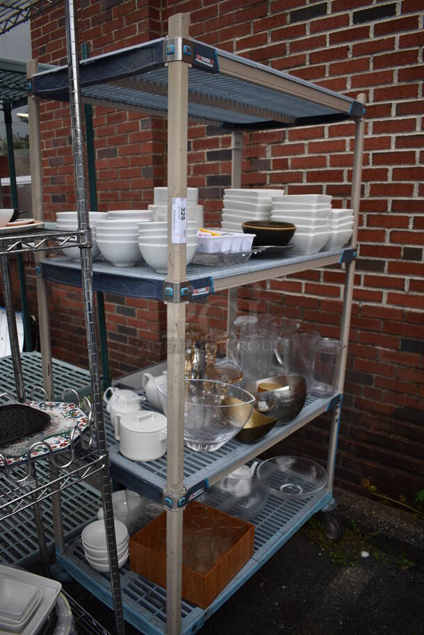 ALL ONE MONEY! Lot of 4 Tiers of Various Smallwares Including White Ceramic Plates, Pitchers. Does Not Include Shelving Unit