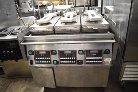2015 Garland XG36 Stainless Steel Commercial Floor Style Natural Gas Powered  Xpress 36" Semi Automatic Triple Clamshell Grill Griddle on Commercial Casters.  