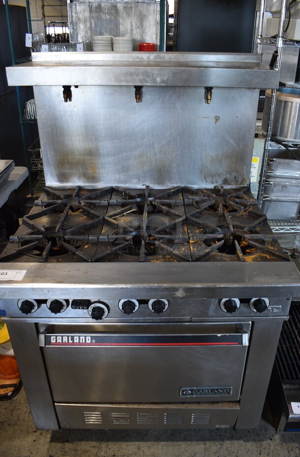 Garland Stainless Steel Commercial Natural Gas Powered 6 Burner Range w/ Oven, Over Shelf and Back Splash. 36x33x59
