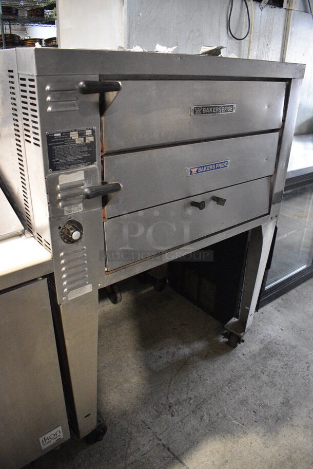 Baker's Pride Model GP61 Stainless Steel Commercial Natural Gas Powered Double Pizza Oven w/ Stones on Metal Legs w/ Commercial Casters. 45,000 BTU. 42x32x55