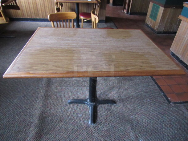 One Wooden Table On A Pedestal Base. 44X32X30