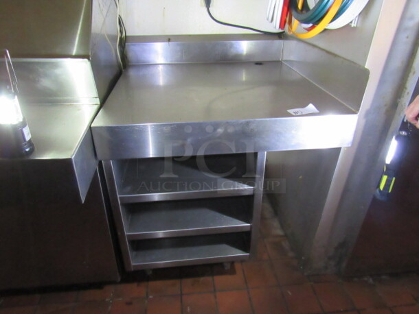 One Stainless Steel Table With 3 Stainless under Shelves, Right Side And Back Splash. 35X35X41. BUYER MUST REMOVE!