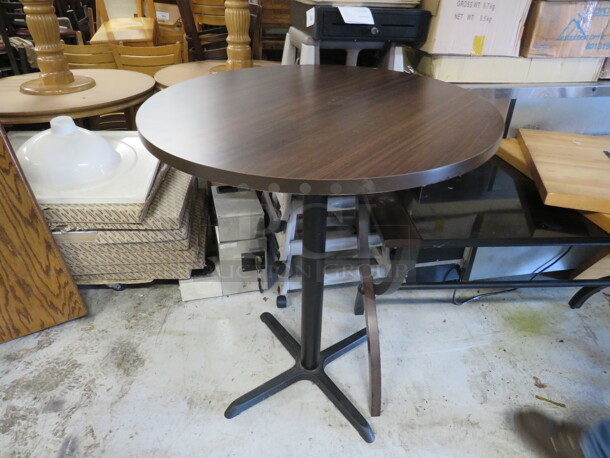 One Brown Laminate Table Top On A Pedestal Base. 30X24X30