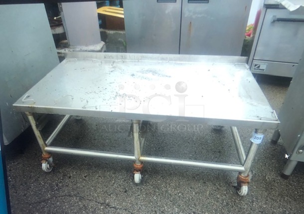 One Stainless Steel Equipment Table On Casters. 52X30X21.5 