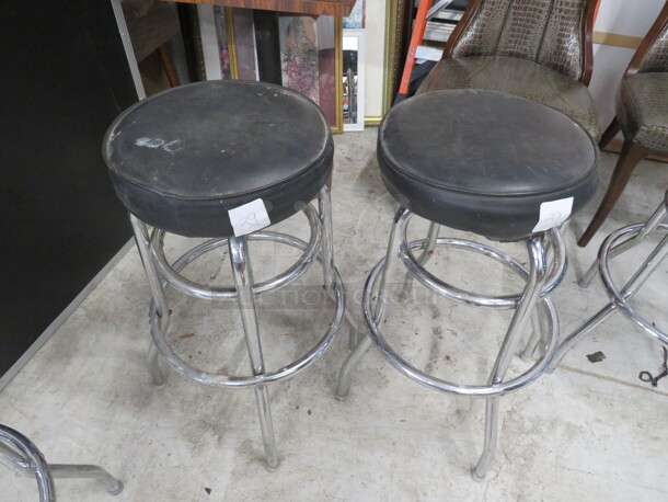 Double Chrome Ring Bar Stool With A Black Cushioned Swivel Seat. Need To Be Recovered. 2XBID - Image 1 of 1