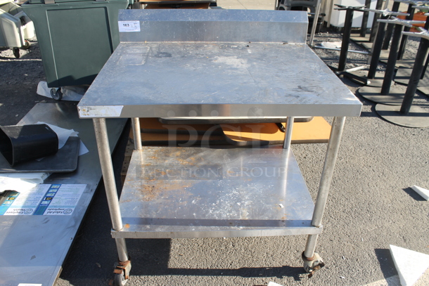 Stainless Steel Table w/ Metal Under Shelf and Back Splash on Commercial Casters.