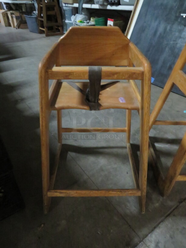 One Wooden High Chair With Safety Straps.