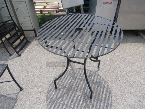 One Black Metal Round Patio Table With Umbrella Hole. 32X32X29
