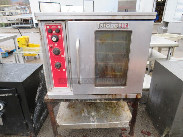One Blodgett Half Size Electric Convection Oven With 5 Racks, On Stainless Steel Table With SS Under Shelf On Casters. 30X27X50