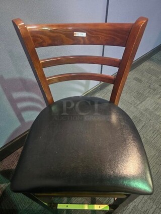 Bar height wooden chairs with black leather seat. In very good condition- no broken pieces. Slight scratches in some places, but still in good shape with lots of life left!  17.5” W x 43” H x 16” D. BIDX3