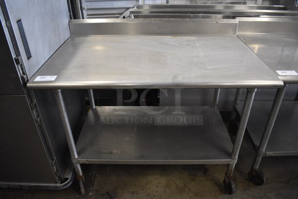 Stainless Steel Commercial Table w/ Under Shelf and Back Splash on Commercial Casters. 48x30x40