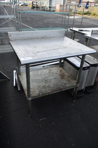 Stainless Steel Commercial Table w/ Back Splash and Under Shelf.