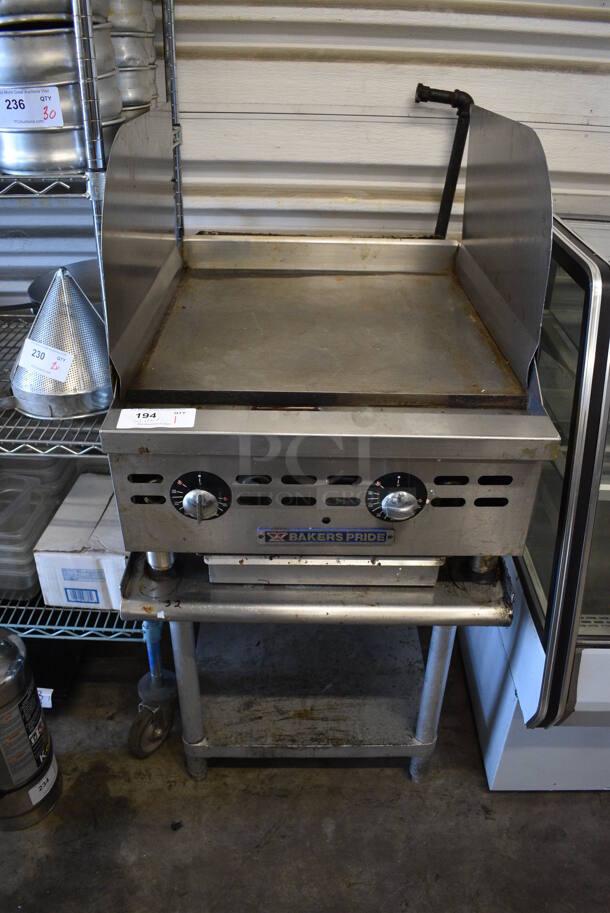 Baker's Pride Stainless Steel Commercial Natural Gas Powered Flat Top Griddle w/ Side Splash Guards and Thermostatic Controls on Stainless Steel Equipment Stand. 24x36x51