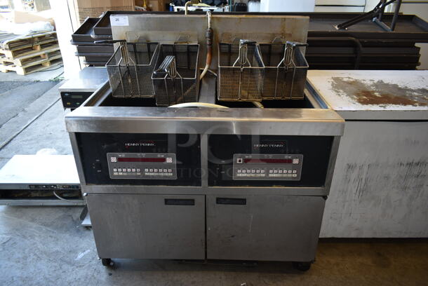 2015 Henny Penny OFG-342 Stainless Steel Commercial Floor Style Natural Gas Powered 2 Bay Deep Fat Fryer w/ Filtration System on Commercial Casters. 240,000 BTU. 