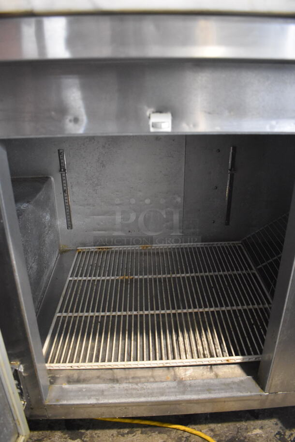 2014 Model Leader ESPT72SC Commercial Stainless Steel Electric Powered Pizza Prep Table With Enclosed Top For Plastic Ingredient Pans, Marble Style Prep Counter With Polycoated Racks on Commercial Casters. 115V Tested And Powers On But Does Not Get Cold - Image 7 of 9