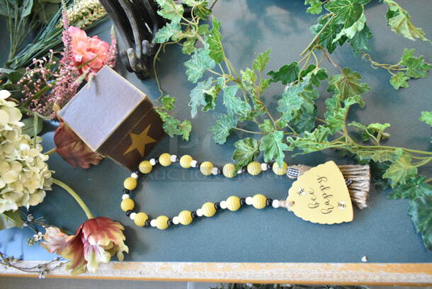 Wall Mount Table w/ Contents Including Spring/Summer Floral Decor. BUYER MUST REMOVE: Bring Tools and Manpower Needed To Remove This Item. (booth room)  - Image 8 of 9