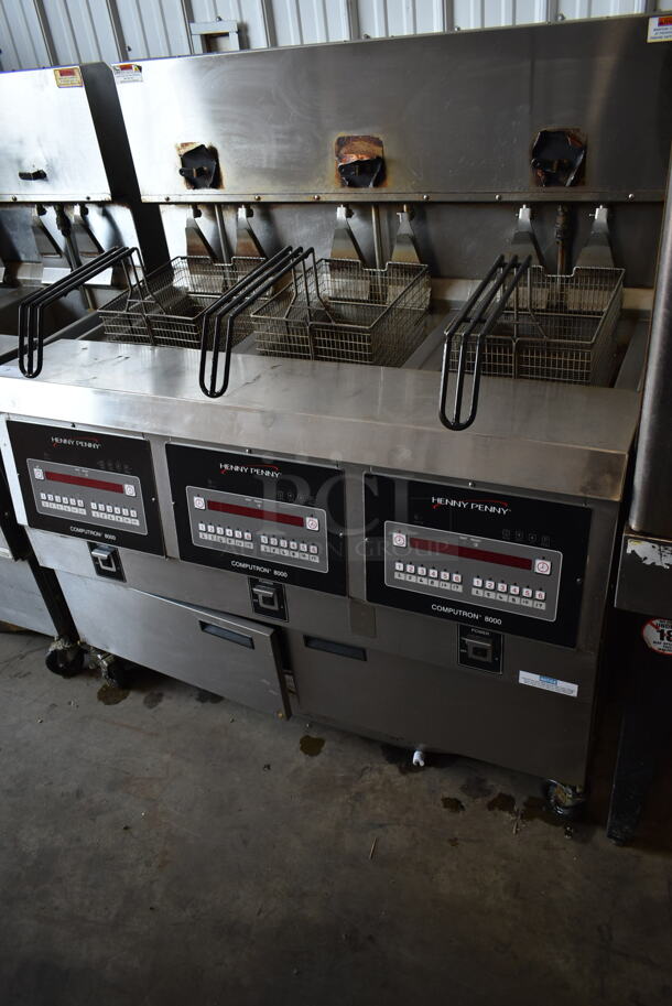 2020 Henny Penny OGA-323 ENERGY STAR Stainless Steel Commercial Natural Gas Powered 3 Bay Fryer w/ 3 Metal Fry Baskets on Commercial Casters. 255,000 BTU. - Item #1111444