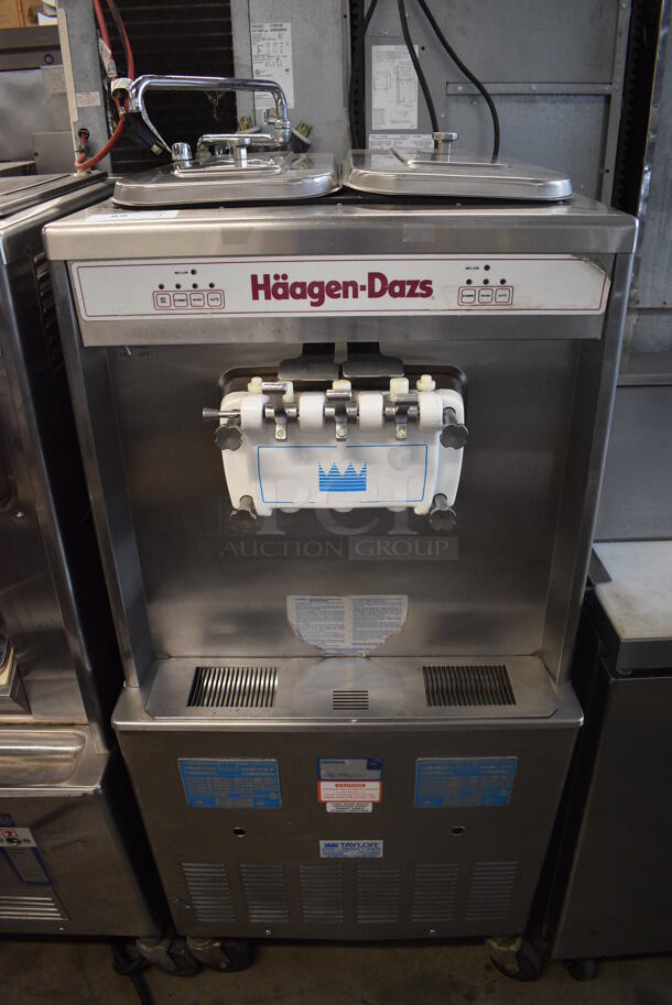Taylor Model 754-33 Stainless Steel Commercial Floor Style Water Cooled 2 Flavor w/ Twist Soft Serve Ice Cream Machine on Commercial Casters. 208-230 volts, 3 Phase. 26x34x60