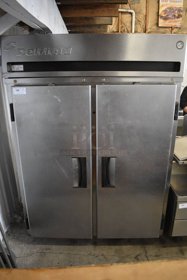 Delfield Model MRR2-S Stainless Steel Commercial 2 Door Reach In Cooler w/ Poly Coated Racks on Commercial Casters. 115 Volts, 1 Phase. 56x34x79. Tested and Powers On But Temps at 51 Degrees