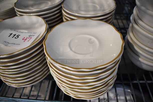 47 White Ceramic Saucers w/ Gold Colored Line on Rim. 5.75x5.75x1. 47 Times Your Bid!