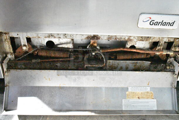 Garland M45R Stainless Steel Commercial Natural Gas Powered Flat Top w/ Oven, Over Shelf and Back Splash on Commercial Casters.  - Image 7 of 8