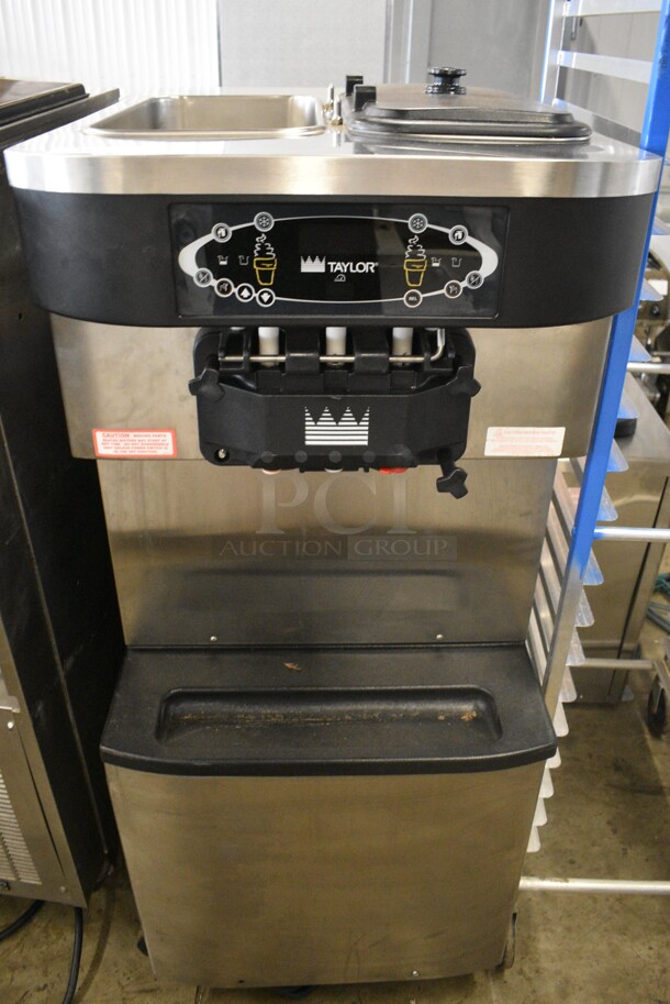 2012 Taylor Model C713-33 Stainless Steel Commercial Floor Style 2 Flavor w/ Twist Soft Serve Ice Cream Machine on Commercial Casters. 208-230 Volts, 3 Phase. 25x36x60