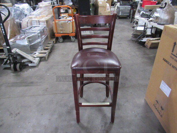 Wooden Bar Stool With A Cushioned Seat And Footrest. 2XBID