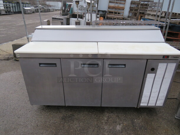 One WORKING Delfield 3 Door Refrigerated Prep Table With Cutting Board, And 5 Racks On Casters. 115 Volt. Model# F18RC68. 67X32X40. $8004.00.