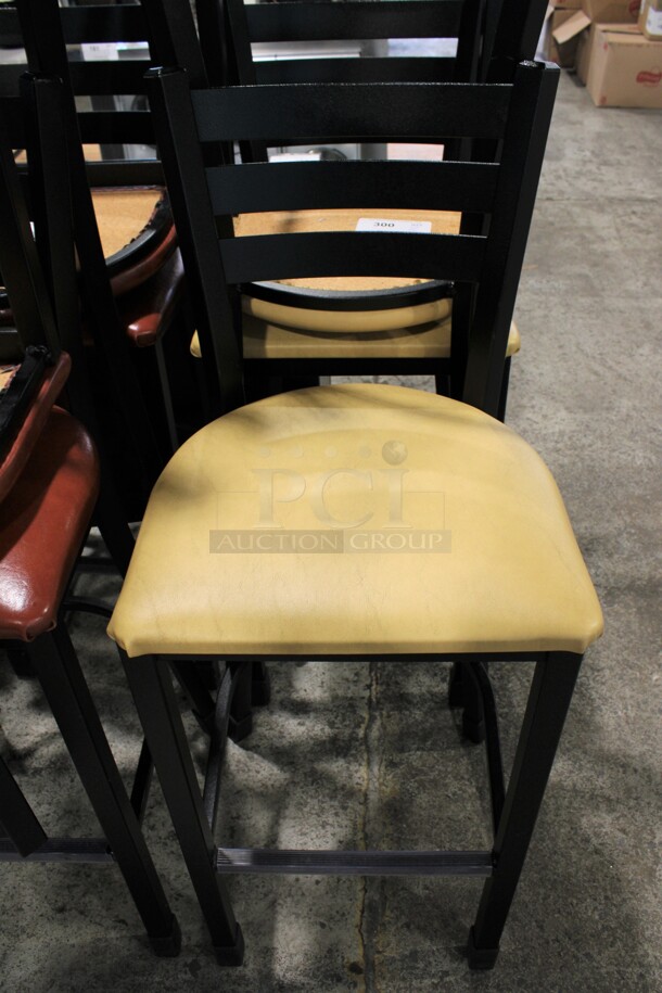 2 Black Metal Bar Height Chairs w/ Yellow/Tan Seat Cushion. 17x16x43. 2 Times Your Bid! - Image 1 of 3