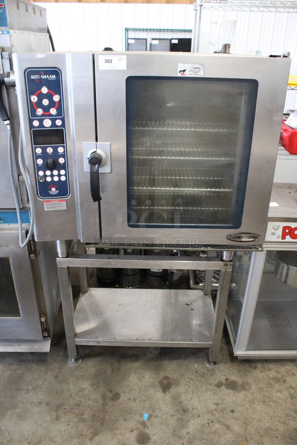 Alto Shaam Model 10.10 ESI Stainless Steel Commercial Electric Powered Combitherm Convection Oven w/ View Through Door and Metal Oven Racks on Stainless Steel Equipment Stand. 208-240 Volts, 3 Phase. 44x33x69
