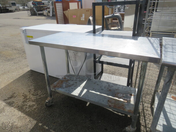 One Stainless Steel Table With Undershelf On Casters. 48X24X34