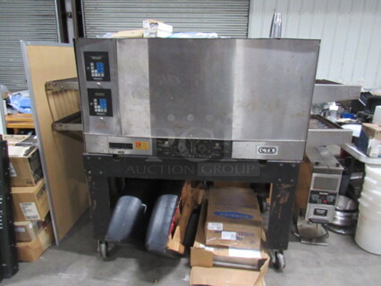One CTX Double Stack Conveyor Pizza Oven On Casters. Model# DZ5511. 208 Volt. 3/1 Phase. 83X36X60.5