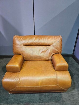 Oversized light brown chair. Chateau D’ax brand and in good condition with some signs of use and wear, but still a very nice chair. Nothing broken. Measures 39” H x 46” W x 40” D.  

