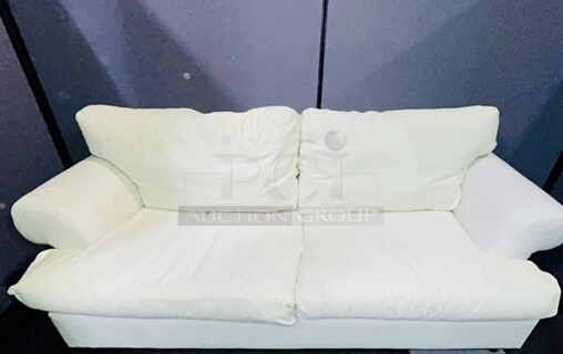 Off white colored love seat- In good condition. Has discoloration spotting on left side, hard to photograph. Can be dyed or reupholstered. No tears, comfy and plush. 82” W x 42” H x 43” D