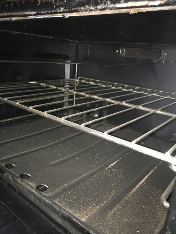 AN ANMAZING FIND! Garland 8 Burner Stove! With Left Side Hot Plate! With Back Splash! With 2 Full Size Ovens Underneath! With Metal Oven Racks! All Stainless Steel! On Casters! - Image 8 of 10