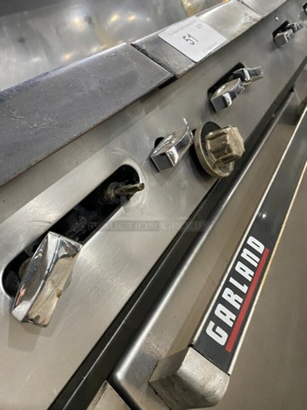 AMAZING FIND! Garland Natural Gas Powered 12 Burner Stove! With 2 Full-Sized Ovens! With Metal Oven Racks! With Raised Back Splash & Salamander Shelf! Stainless Steel! On Casters! - Image 8 of 9