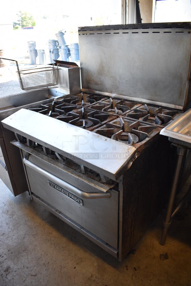 Baker's Pride Stainless Steel Commercial Natural Gas Powered 6 Burner Range w/ Oven and Back Splash on Commercial Casters. 36x34x56