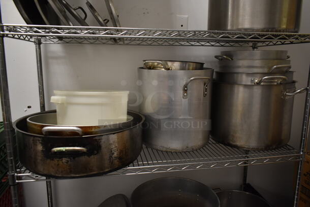 Metro Chrome Finish 4 Tier Wire Shelving Unit w/ Contents Including Metal Stock Pots on Commercial Casters. BUYER MUST REMOVE: BUYER MUST DISMANTLE. PCI CANNOT DISMANTLE FOR SHIPPING. PLEASE CONSIDER FREIGHT CHARGES. (kitchen) - Image 4 of 5