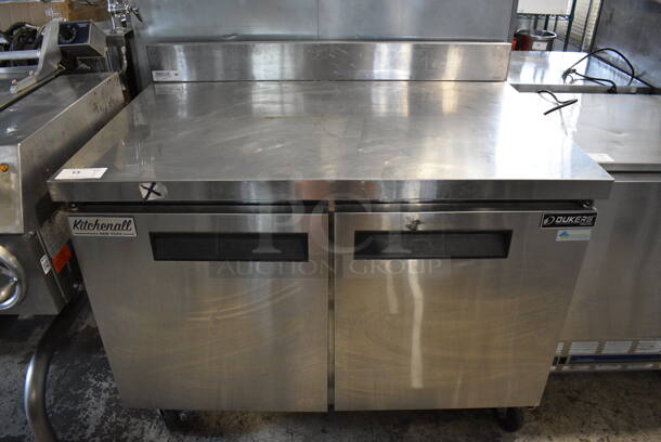 Dukers Model DUC48F Stainless Steel Commercial 2 Door Work Top Freezer on Commercial Casters. 115 Volts, 1 Phase. 48x31.5x36. Tested and Powers On But Does Not Get Cold