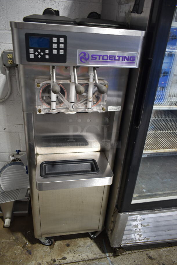 2014 Stoelting F231-109I2YGAD1 Stainless Steel Commercial Floor Style Water Cooled 2 Flavor w/ Twist Soft Serve Ice Cream Machine on Commercial Casters. 208-240 Volts, 3 Phase. 