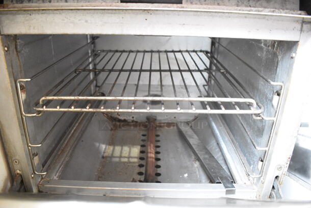 Cooking Performance Group CPG 351S24N Stainless Steel Commercial Natural Gas Powered 4 Burner Range w/ Oven and Back Splash on Commercial Casters. 150,000 BTU.  - Image 5 of 6