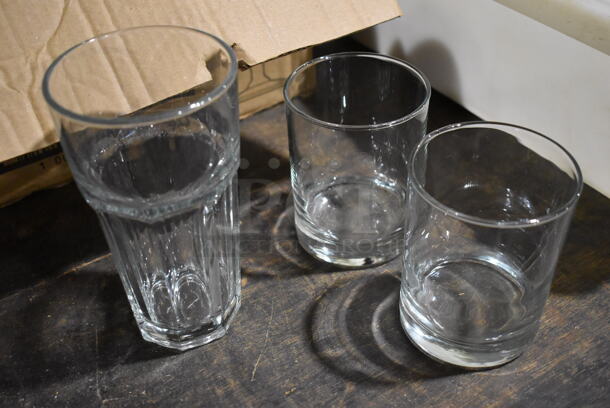 9 Various Glasses; 8 Rocks Glasses and 1 Beverage Glass. 3.5x3.5x6.5, 3.25x3.25x4. 9 Times Your Bid!
