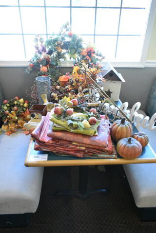 Wall Mount Table w/ Contents Including Fall Decor. BUYER MUST REMOVE: Bring Tools and Manpower Needed To Remove This Item. (booth room) 