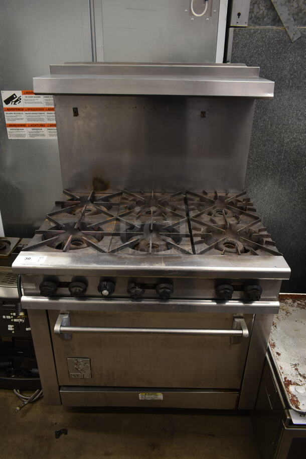 Wolf Stainless Steel Commercial Natural Gas Powered 6 Burner Range w/ Oven, Over Shelf and Back Splash on Commercial Casters.