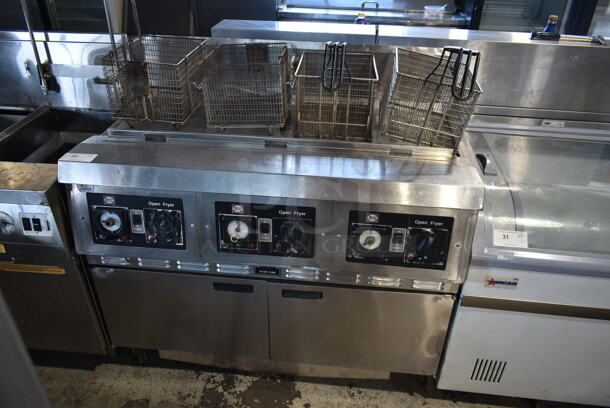 Henny Penny CG-303 Stainless Steel Commercial Floor Style  Natural Gas Powered 3 Bay Deep Fat Fryer w/ 3 Lids and 4 Metal Fry Baskets on Commercial Casters. 240,000 BTU.