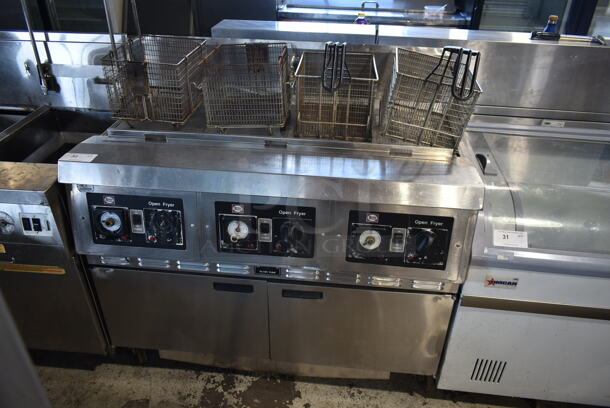 Henny Penny CG-303 Stainless Steel Commercial Floor Style  Natural Gas Powered 3 Bay Deep Fat Fryer w/ 3 Lids and 4 Metal Fry Baskets on Commercial Casters. 240,000 BTU. - Image 1 of 10