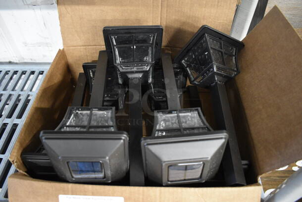 9 Black Solar Powered Path Lights. Almost All Units Are BRAND NEW, Others Are Lightly Used. 5x5x12.5. 9 Times Your Bid!