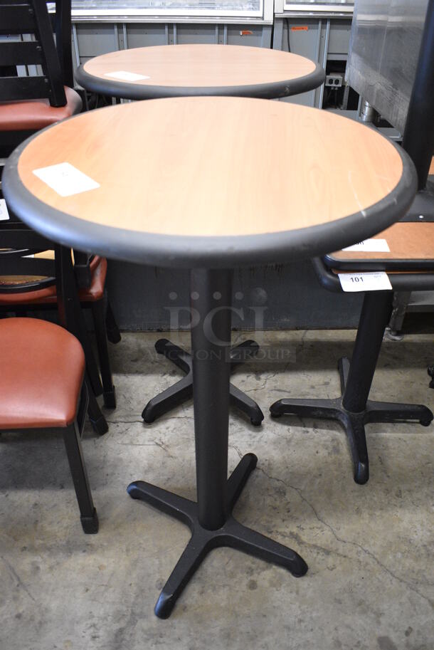 Wood Pattern Round Bar Height Table on Black Metal Table Base. Stock Picture - Cosmetic Condition May Vary. 24x24x42
